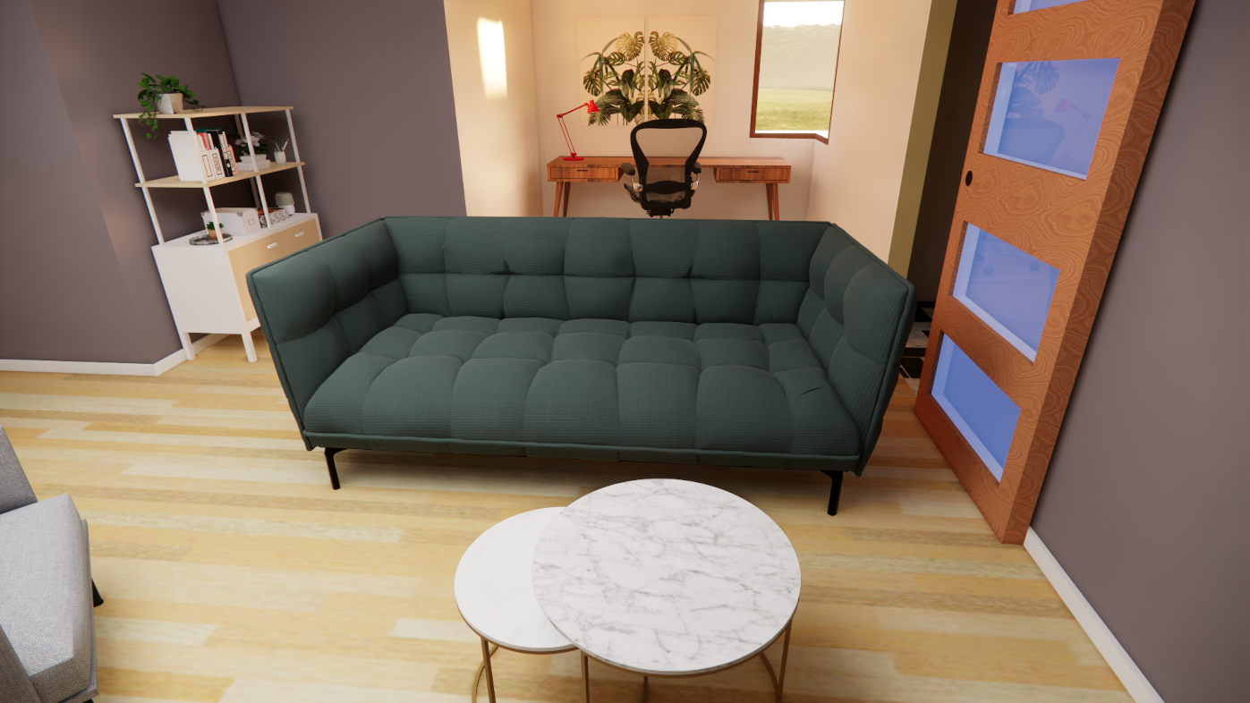 A view of a living room facing the sofa, showing a desk behind it, which has an outlook to the garden.